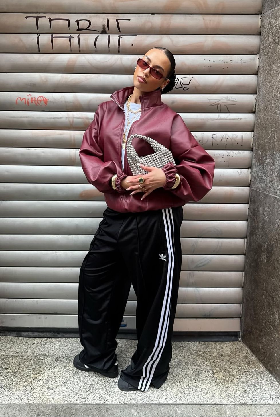 Track pants with zip-front jacket and beaded mini bag